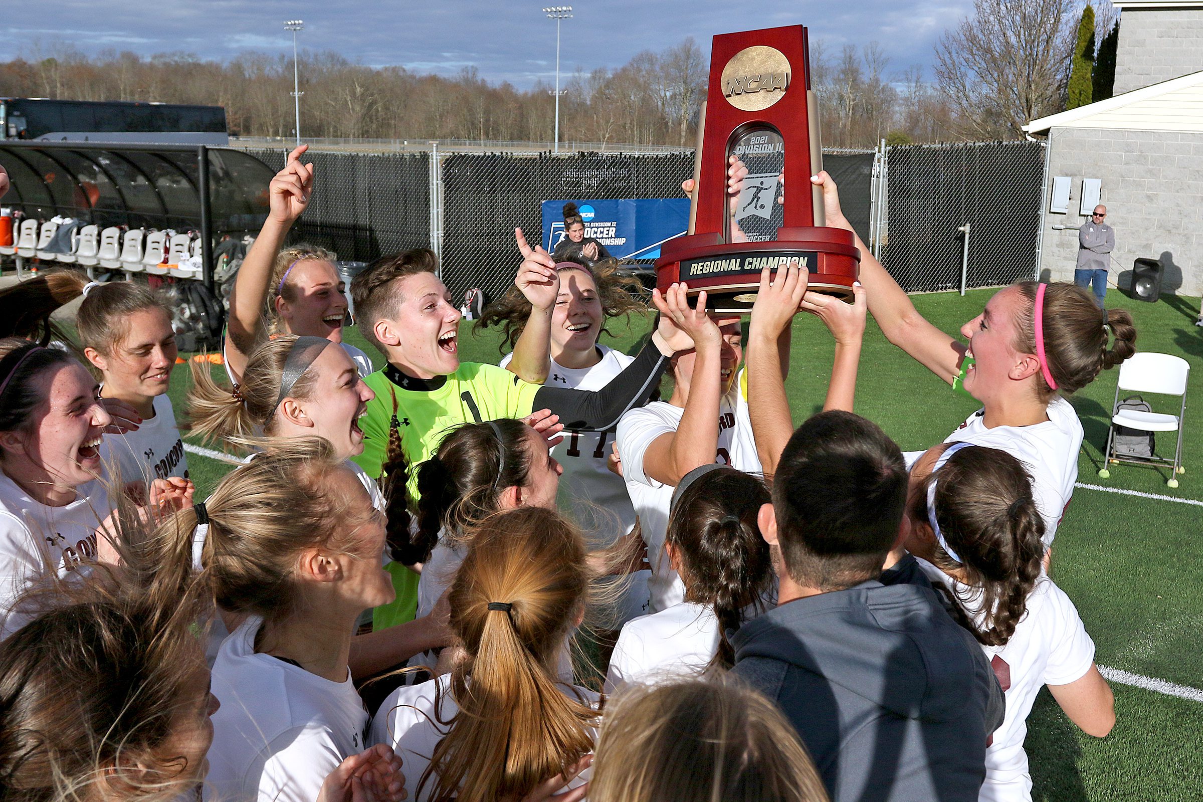 (Brad Davis/For LootPress) Concord players celebrate with the trophy after defeating West Chester in the NCAA Division 2 Tournament Thursday afternoon at the YMCA Paul Cline Memorial Sports Complex.